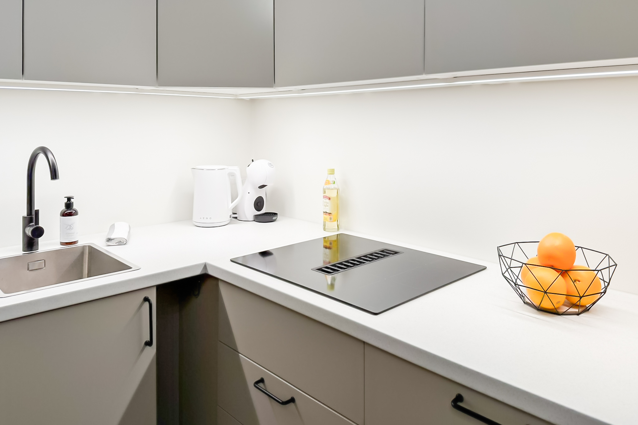 Kuressaare Stays apartment kitchen with induction stove, kettle, coffee machine.