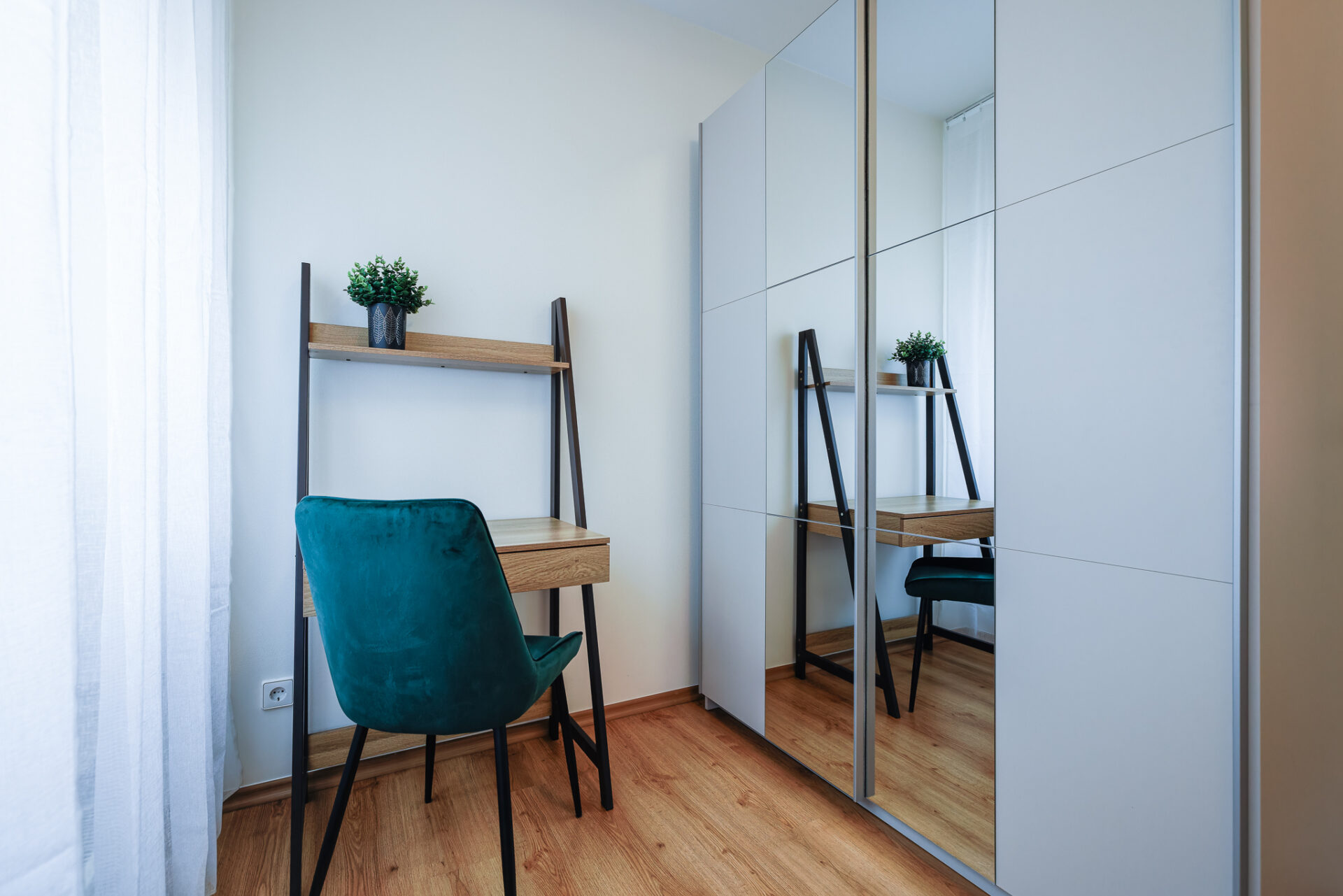 Workspace and mirrored wardrobe at Kuressaare Stays apartment in Kuressaare